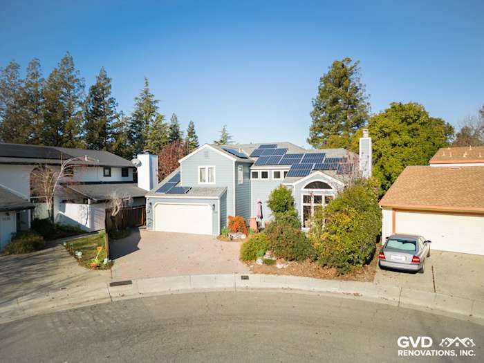 Home exterior featuring Boothbay Blue James Hardie siding, solar panels, and landscaped front yard in Davis, CA