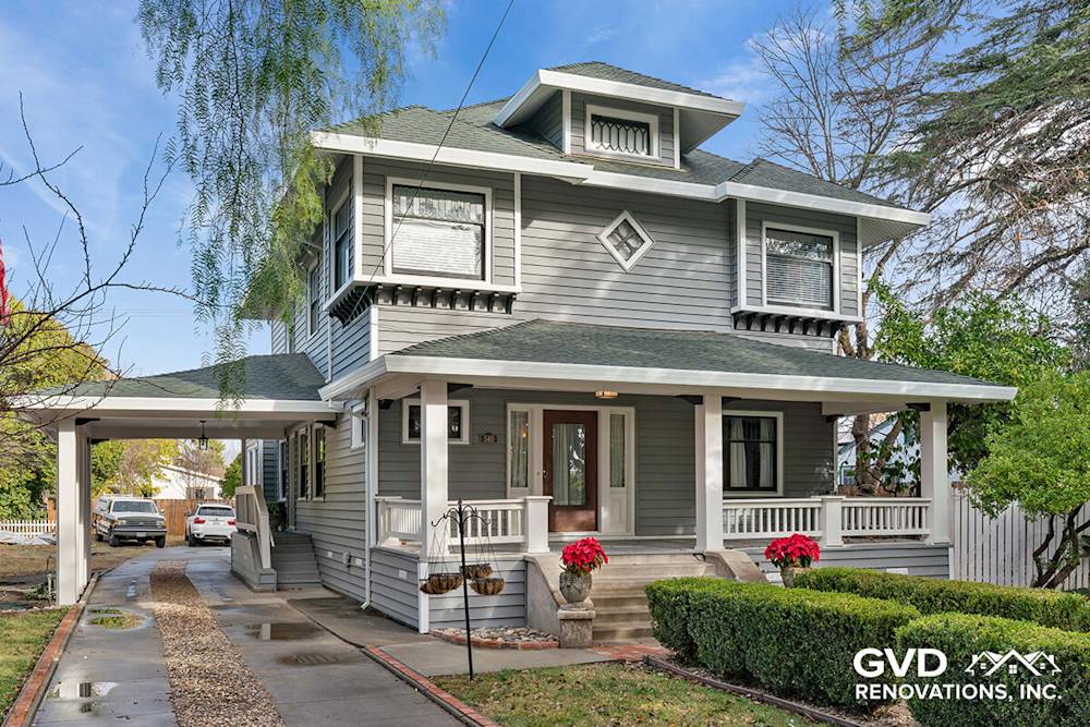 Fresh gray siding, modern trim, and updated landscaping enhance curb appeal