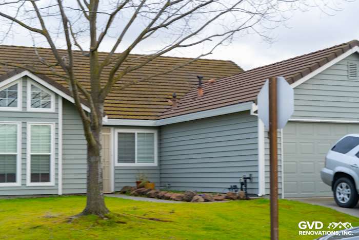 Home exterior featuring Prodigy Solid Core Insulated Siding in gray, painted eaves, and new gutters in Sacramento