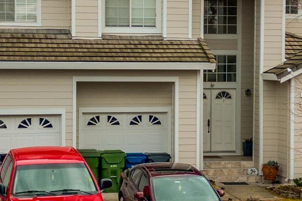 Petaluma home featuring new James Hardie Cobble Stone siding and Arctic White trim, with parked vehicles
