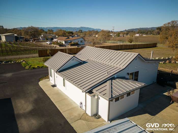Home exterior in Sonoma featuring newly installed Arctic White James Hardie siding and modern metal roof