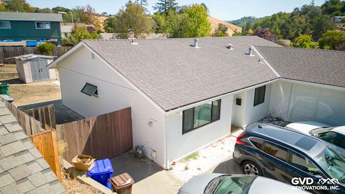 Renovated home exterior featuring James Hardie Arctic White siding and new windows in Pinole, CA