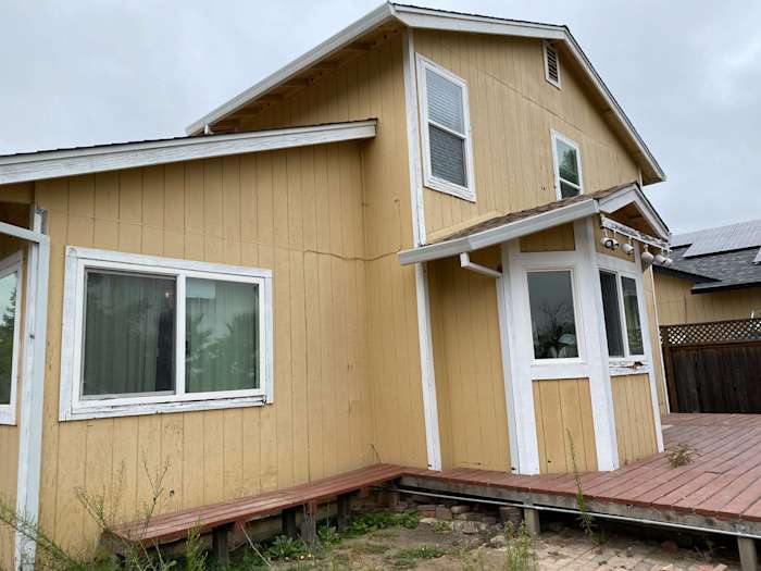 Newly installed James Hardie siding on a unique home exterior in Santa Rosa, showcasing yellow wood with white trim