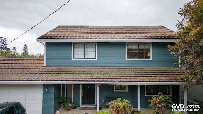 Two-story home exterior featuring Evening Blue Cedarmill HardiePlank siding and Rustic Grain Arctic White HardieTrim