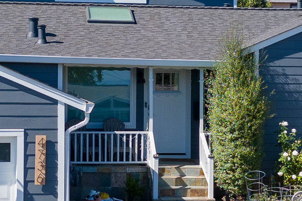 Home exterior featuring James Hardie Night Gray siding, Arctic White trim, Anlin windows, and landscaped front yard
