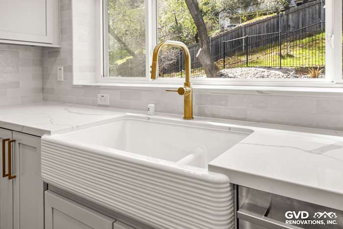 Farmhouse sink with gold faucet and quartz countertop in a modern El Dorado Hills kitchen remodel