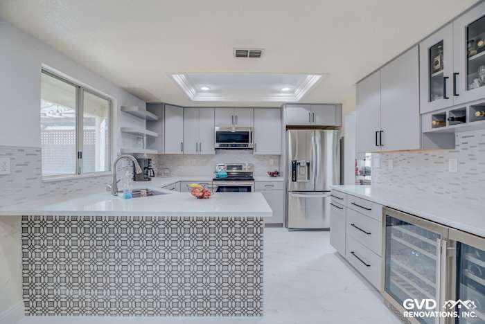 Modern kitchen remodel featuring gray cabinetry, quartz countertops, and mosaic tile backsplash in Sacramento