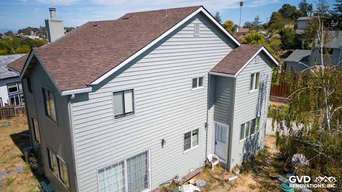 Newly installed Alside Prodigy vinyl siding in light gray with Mezzo windows on home exterior in El Sobrante