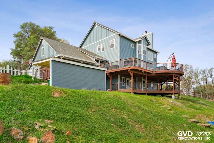 New James Hardie siding in a blue hue on a two-story home with a large deck in Shingle Springs