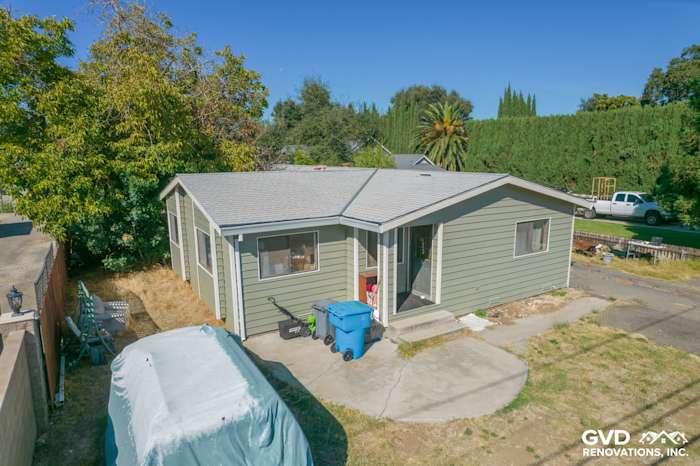 Single-story home exterior featuring Prodigy siding in green, new roof, and landscaped yard in Yuba City