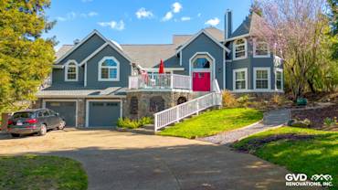 Home exterior featuring Night Gray James Hardie siding, Arctic White trim, and a bright red door in Petaluma, CA