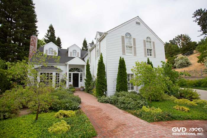 Home exterior featuring Arctic White James Hardie siding, trim, and landscaped pathway in Orinda, CA