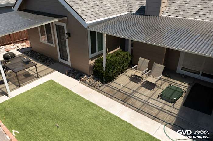 Updated home exterior featuring James Hardie Artisan Lap Siding in Khaki Brown and Arctic White trim, with outdoor patio