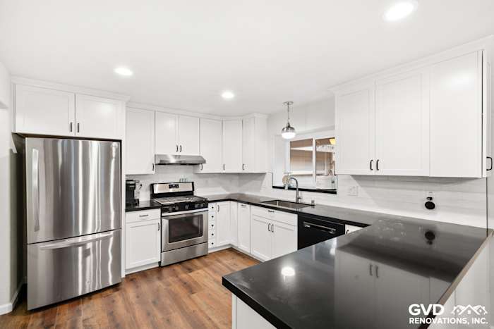 Modern white shaker kitchen with stainless steel appliances and black countertop in Loomis, CA