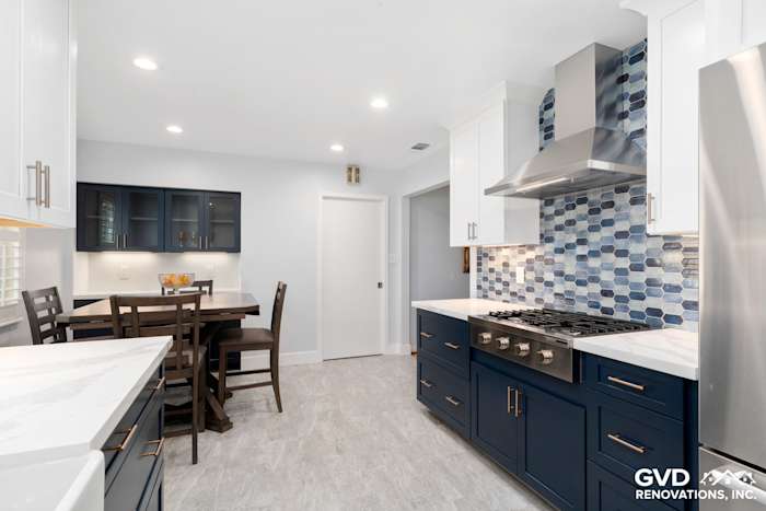 Modern Sacramento kitchen remodel featuring navy cabinets, quartz countertops, and a blue mosaic backsplash