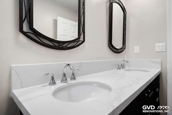 Modern bathroom vanity with white quartz countertop, dual sinks, and elegant mirrors in Rocklin, CA remodel