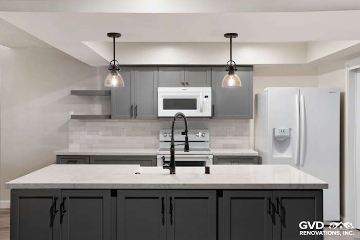Modern kitchen remodel featuring gray cabinets, quartz countertop, and pendant lighting in Sacramento