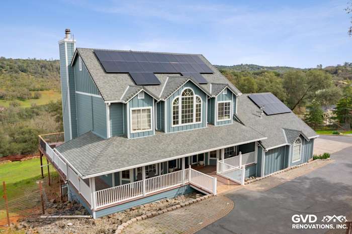 New blue James Hardie siding and covered porch on a modern Shingle Springs home with solar panels