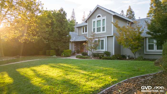 Home exterior featuring James Hardie Cedarmill siding in Monterey Taupe with Arctic White trim and landscaped yard