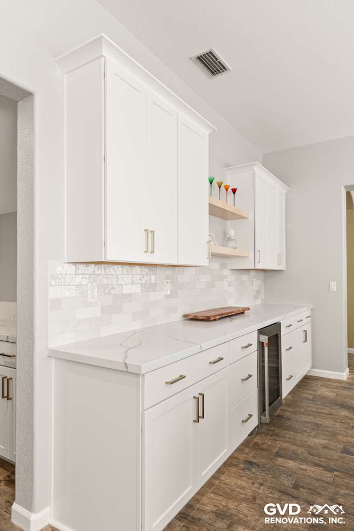 Modern kitchen with Diamond cabinets, floating shelves, MSI countertops, and a sleek backsplash in Roseville, CA