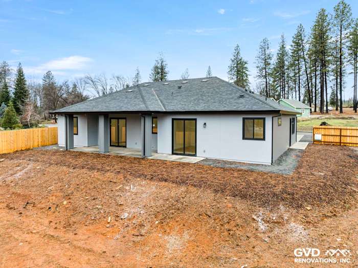 Newly built home exterior in Paradise, CA featuring James Hardie siding, Milgard black windows, and a modern design