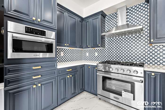 Stylish Sacramento kitchen remodel featuring navy blue cabinets, stainless steel appliances, and geometric backsplash