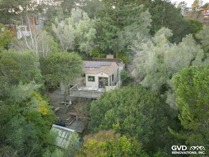 Home exterior featuring James Hardie Khaki Brown siding and Marvin windows surrounded by lush greenery