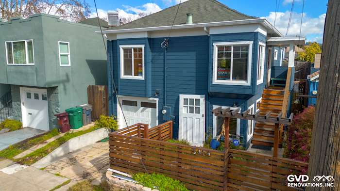 New Evening Blue James Hardie siding with Arctic White trim on a remodeled Oakland home exterior