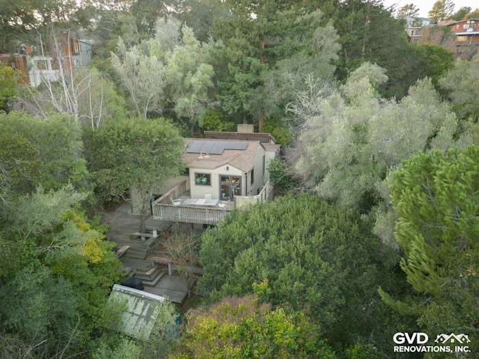 Home exterior featuring James Hardie Khaki Brown siding, Marvin windows, surrounded by lush greenery in Oakland