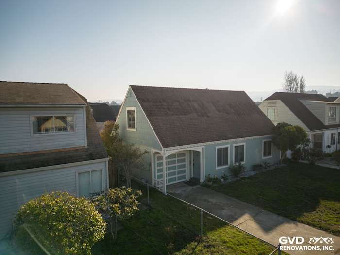 Home exterior featuring newly installed James Hardie Artisan Lap Siding in light blue, surrounded by greenery in South San