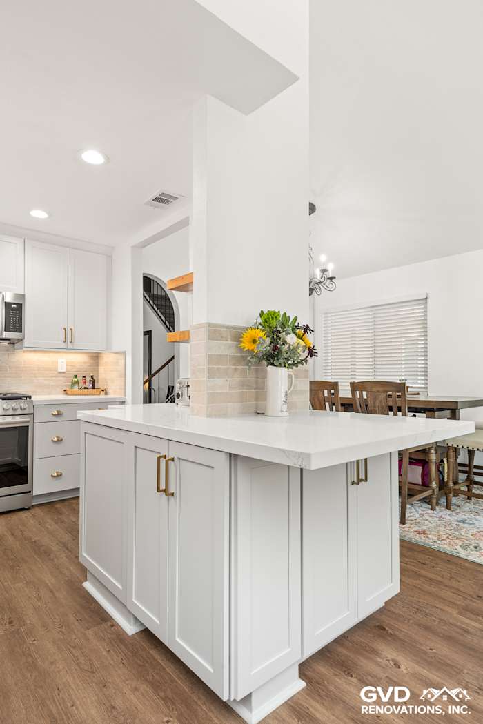 Modern kitchen in Roseville featuring Waypoint Painted Harbor cabinetry, Vadara Naurelle stone island, and elegant