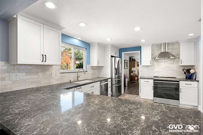 Modern kitchen remodel in Fair Oaks featuring white cabinets, gray quartz countertop, and stainless steel appliances