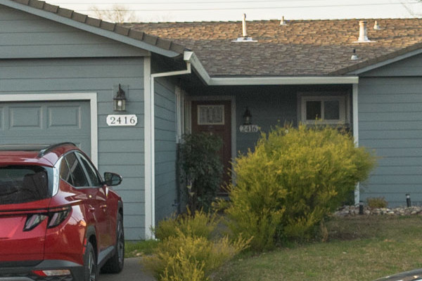 Modern home exterior featuring Boothbay Blue James Hardie siding, painted eaves, and new gutters in Rancho Cordova