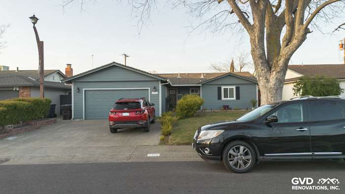 Modern home exterior featuring Boothbay Blue James Hardie siding, painted eaves, and new gutters in Rancho Cordova