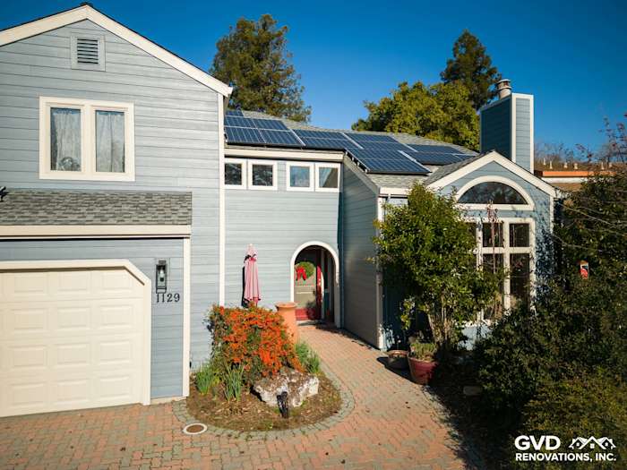 Home exterior featuring James Hardie Boothbay Blue siding, solar panels, and landscaped front entry in Davis, CA
