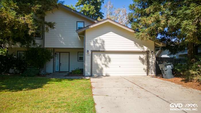 Modern home exterior featuring James Hardie siding and trim in neutral tones, with a well-maintained lawn