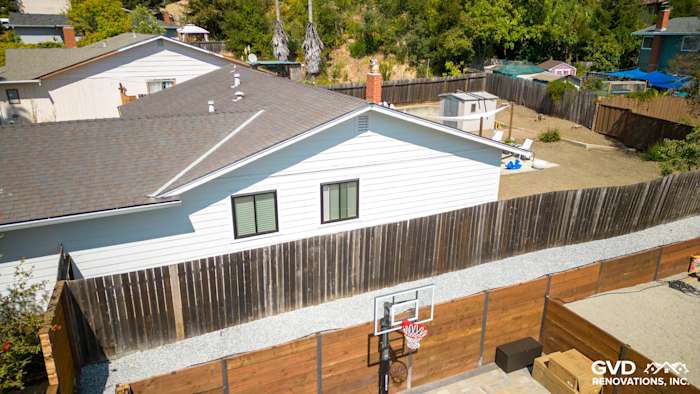 Updated home exterior featuring James Hardie Lap Siding in Arctic White and black windows in Pinole, CA