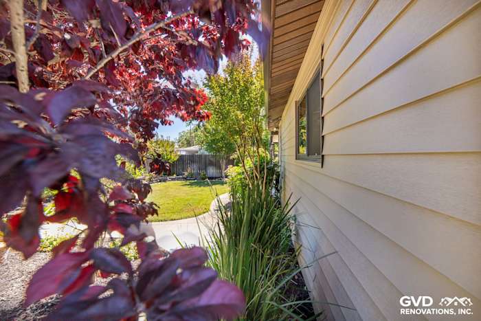 Side view of home featuring new Alside Prodigy vinyl siding and landscaped garden in Rio Linda, CA