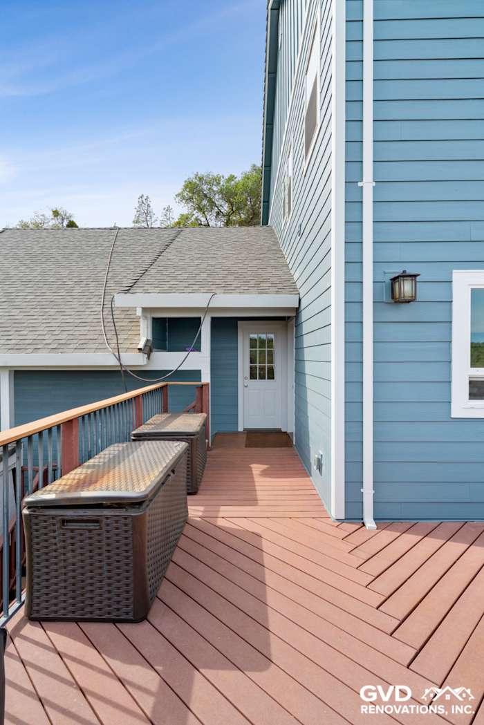 New James Hardie siding on home exterior, showcasing a blue color and connected deck area in Shingle Springs