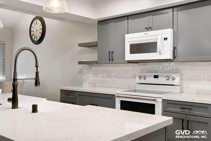 Modern Sacramento kitchen remodel featuring gray cabinets, white quartz countertops, and sleek stainless steel appliances