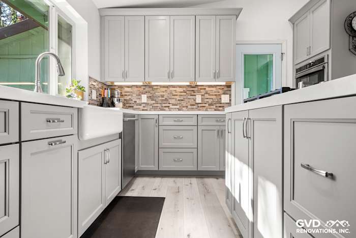 Modern kitchen remodel in Greenwood, CA with gray cabinets, quartz countertops, and mosaic backsplash