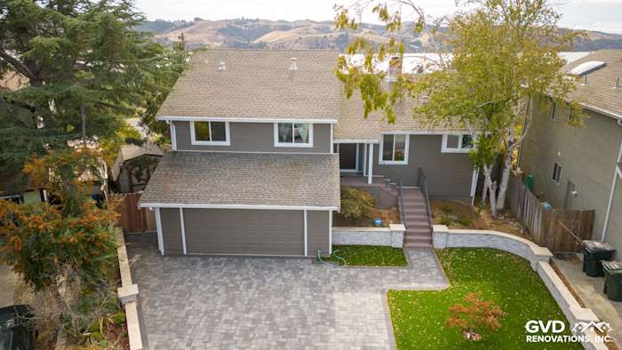 Home exterior featuring Timber Bark James Hardie siding, Arctic White trim, and a paver driveway in Benicia, CA