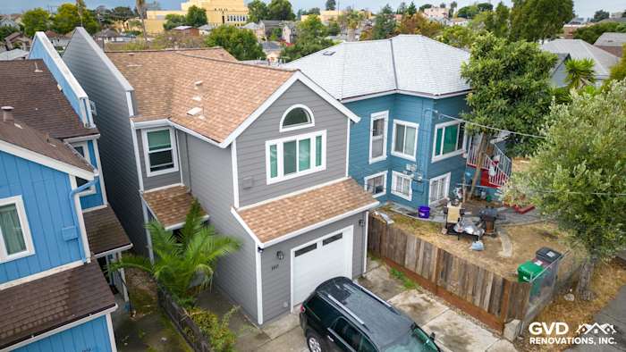A home exterior featuring Aged Pewter James Hardie siding, Arctic White trim, and a new roof in Oakland, CA