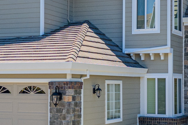 Home exterior transformation in Clayton, CA featuring James Hardie siding, stone accents, and manicured landscaping