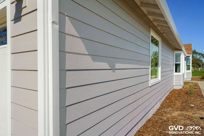 Pearl Gray James Hardie siding with Arctic White trim on a Galt home exterior with new Anlin windows