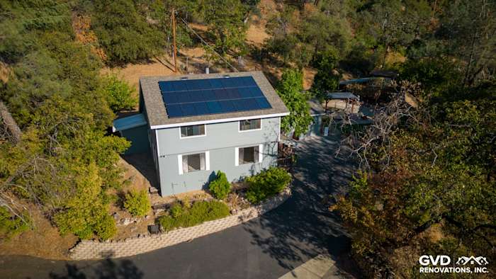 Gray Slate James Hardie lap siding with Arctic White trim on a renovated home in Colfax, CA, featuring solar panels