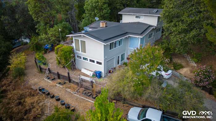 Modern home exterior featuring newly installed James Hardie Cedarmill lap siding in Cobble Stone and Arctic White trim