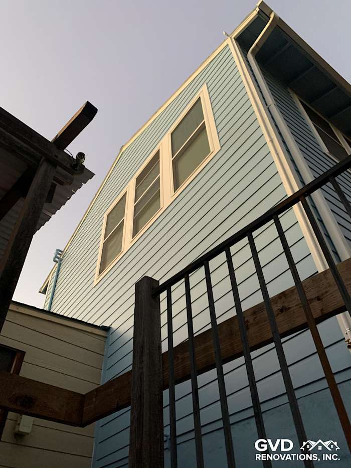 Custom Colonial Smooth Lap James Hardie siding and new vinyl windows on a renovated Oakland home