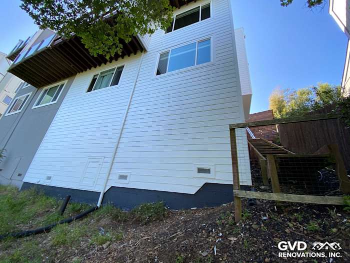 New pre-finished James Hardie lap siding on a Mill Valley home, showcasing clean white panels and framed windows