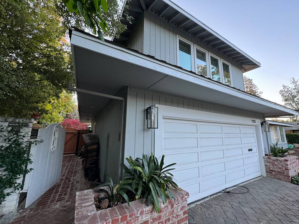 Stylish Sacramento home entry with garage, brick features, and vibrant landscaping